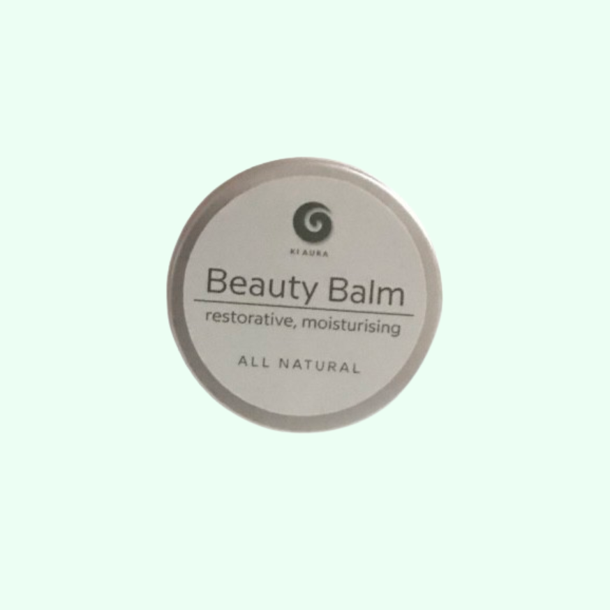 Beauty balm container with 'All Natural' label on a light green background