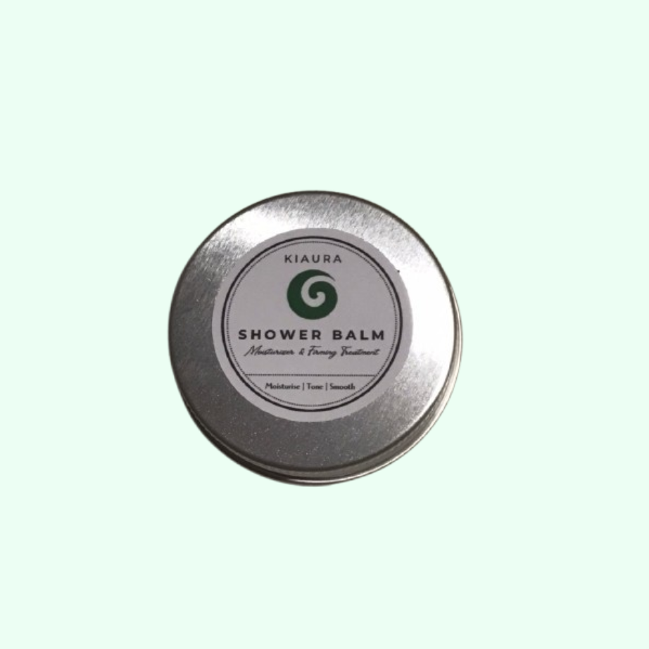 Kiaura Shower Balm tin on a light green background